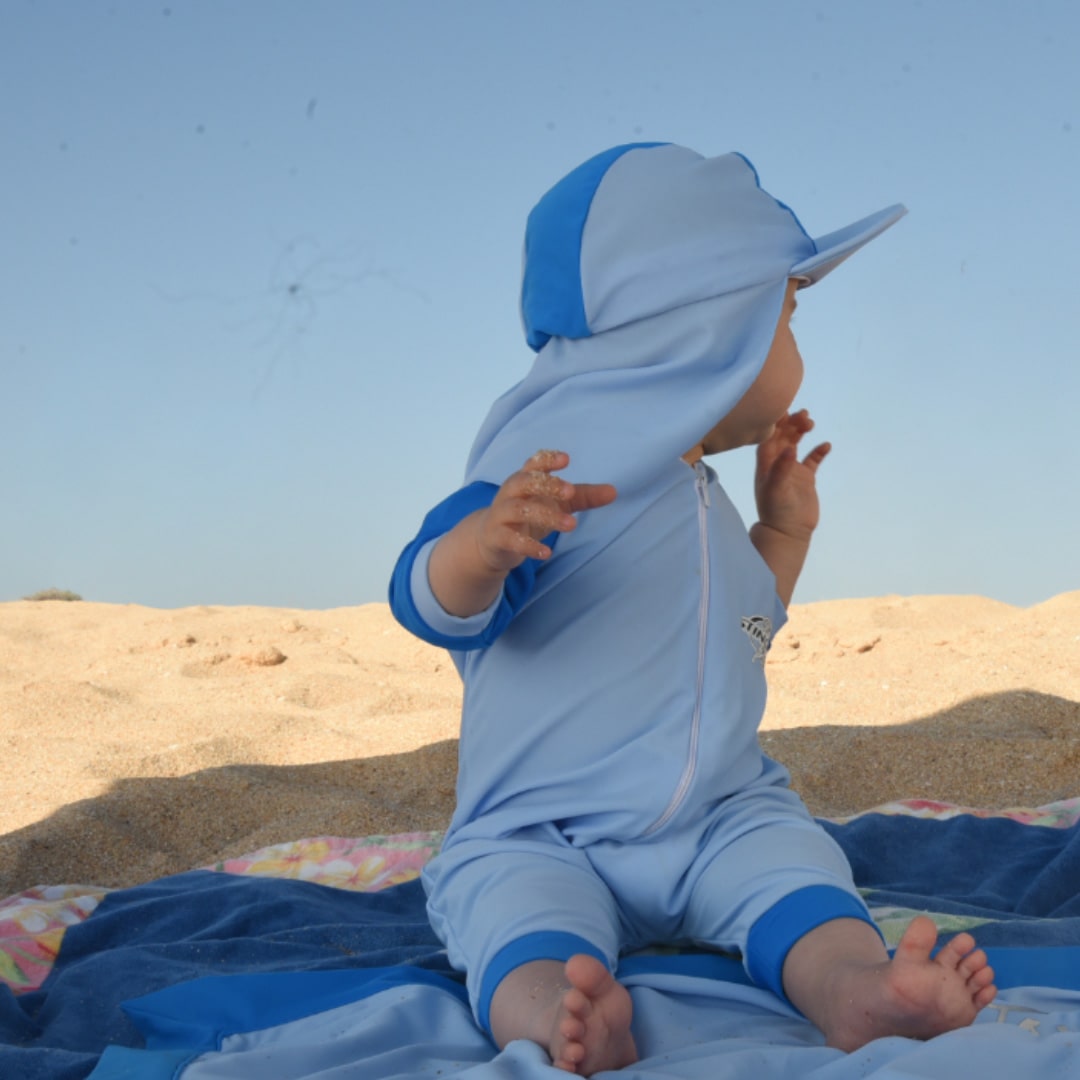 Banner photo of a baby wearing upf 50 sunsuit on the beach for our infant (beachwear) UV protection swimwear and clothing