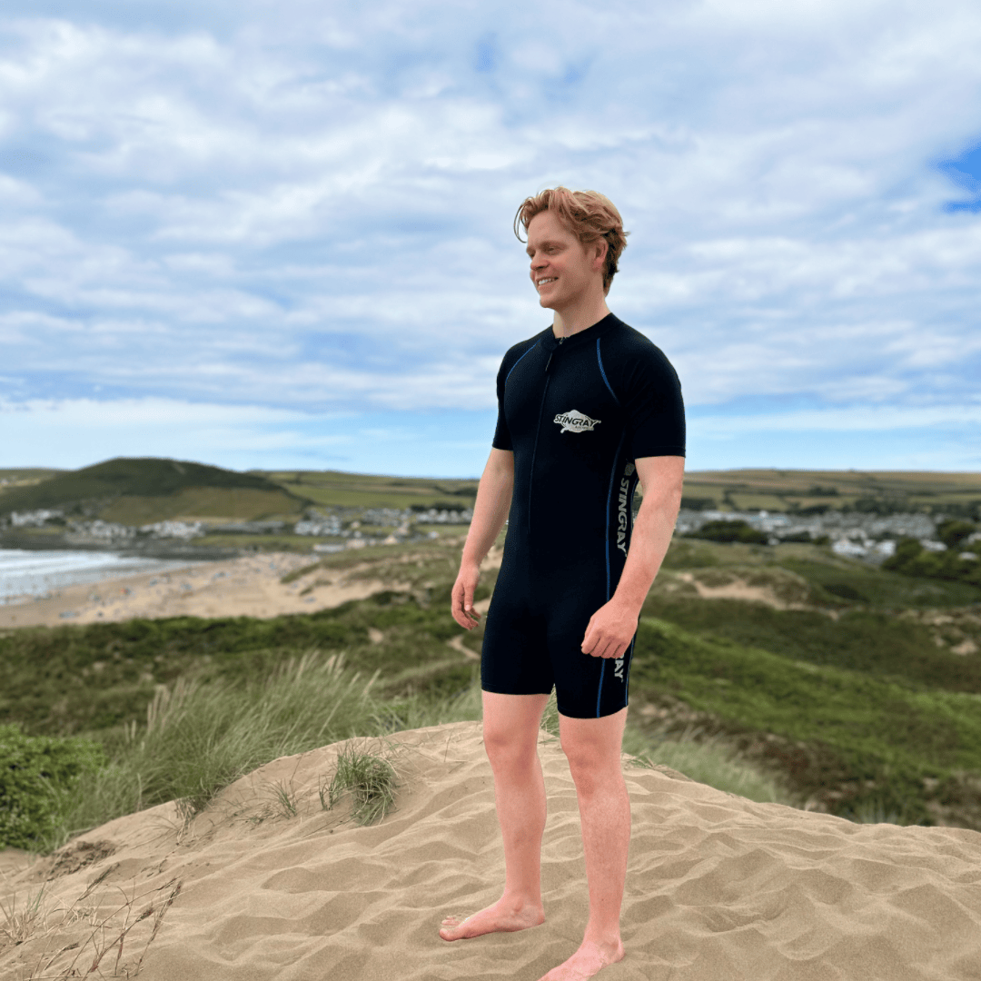 Man wearing a UPF sunsuit on the beach