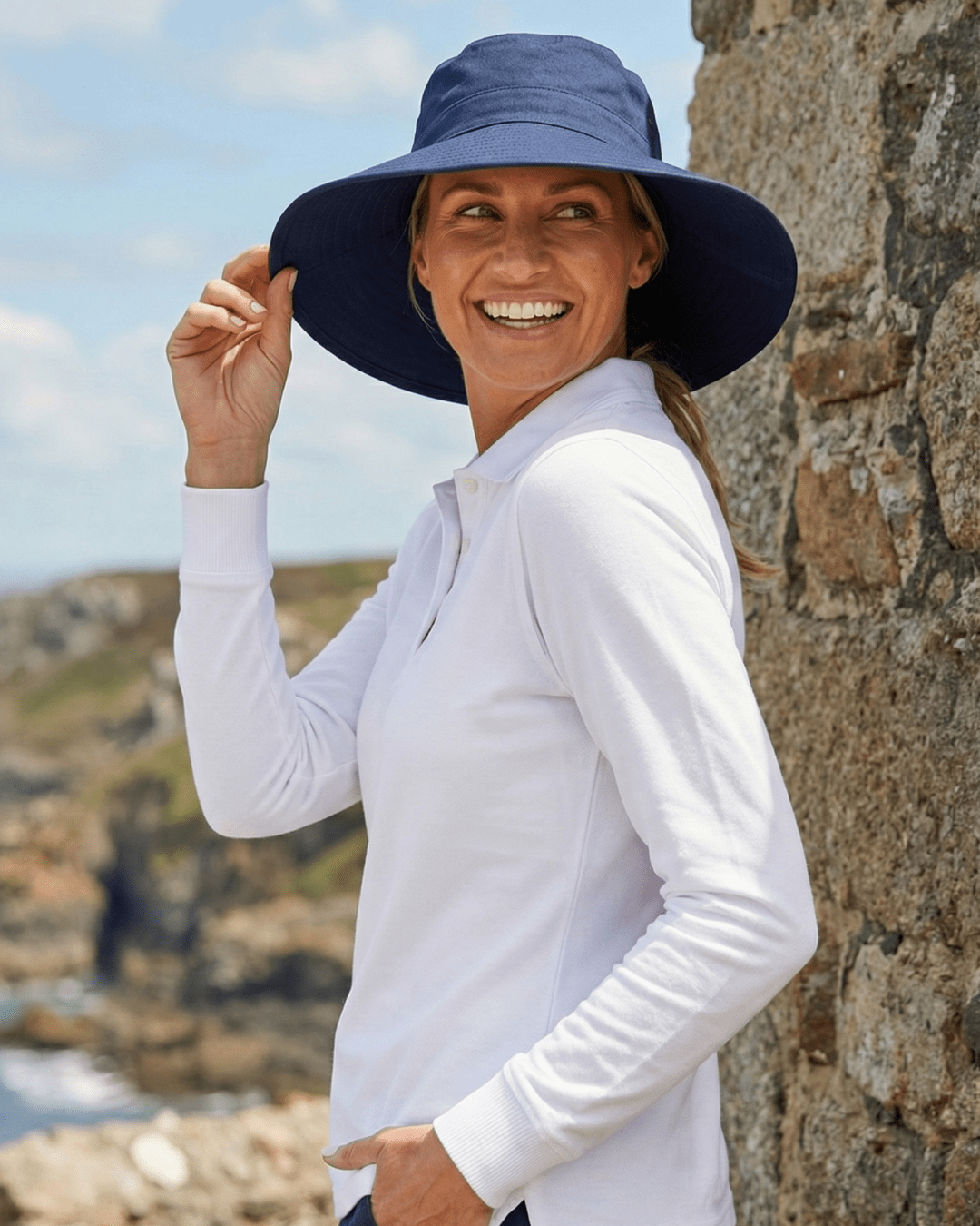 Woman wearing navy blue UV wide brim sun hat