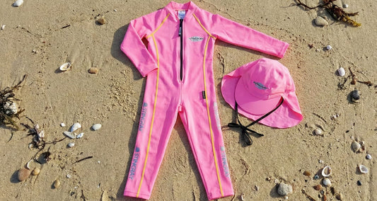Kids UPF swimwear laying flat on the beach