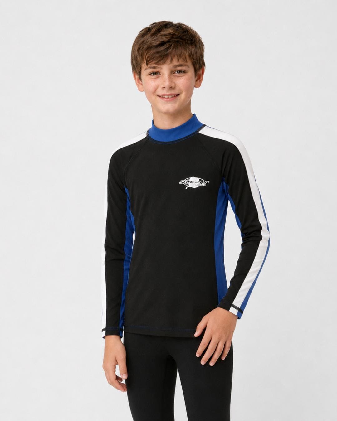 14 year old boy wearing a black, white and blue long-sleeve UV rash shirt on a white background