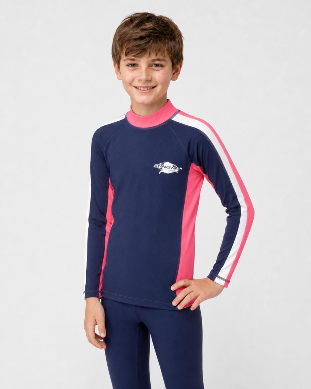 14 year old boy wearing a navy, white and pink long-sleeve UV swim shirt on a white background
