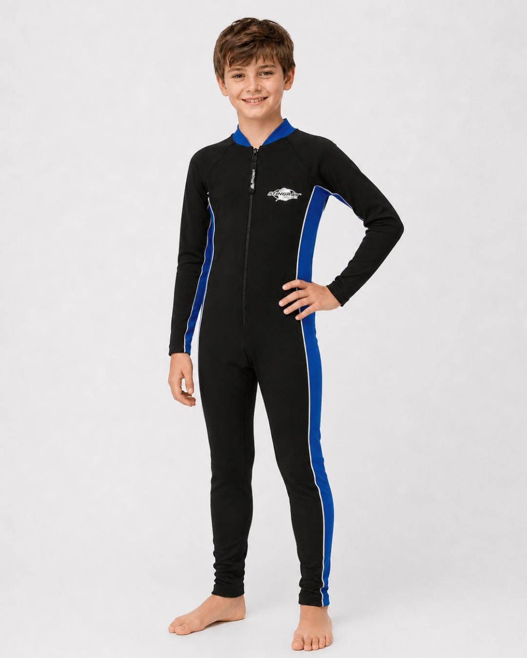14 year old boy wearing a black and blue full-body UV swimsuit on a white background