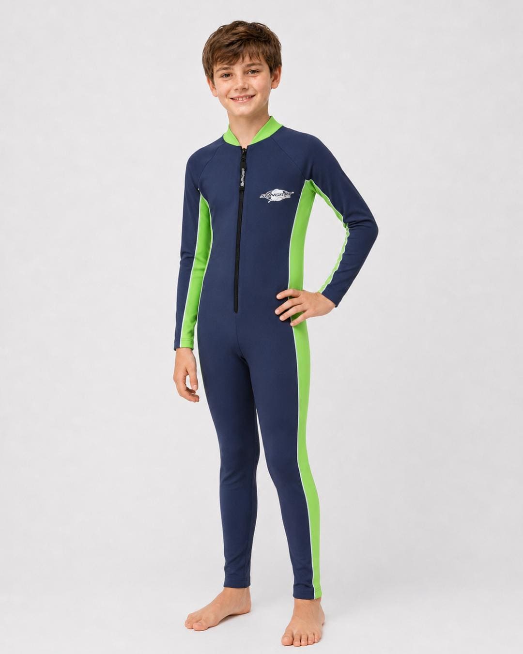 14 year old boy wearing a navy and green full-body UV swimsuit on a white background