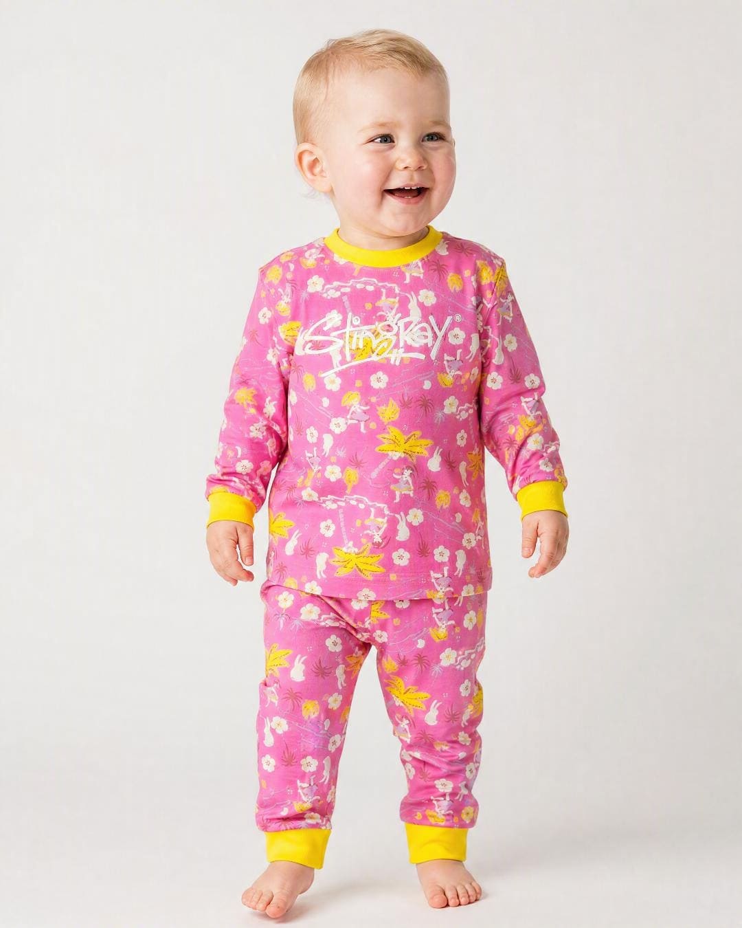 14 month old baby wearing the Stingray 2-piece UV sunsuit set in floral colours, in the studio
