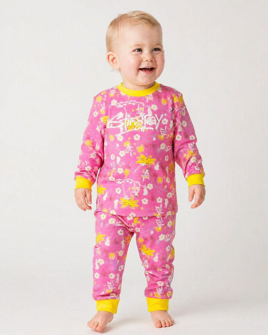 14 month old baby wearing the Stingray 2-piece UV sunsuit set in floral colours, in the studio
