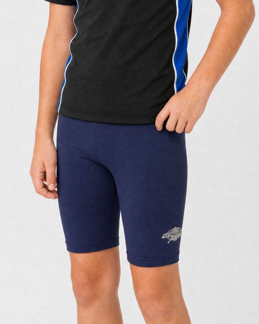 14 year old wearing navy UV swimming shorts/trunks UPF 50+ in a white studio