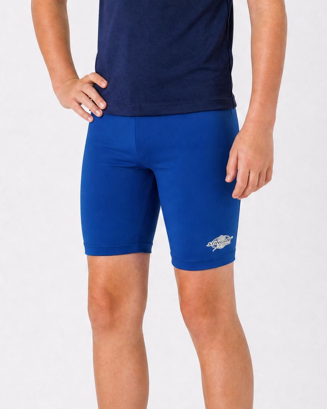 14 year old wearing blue UV swimming shorts/trunks UPF 50+ in a white studio