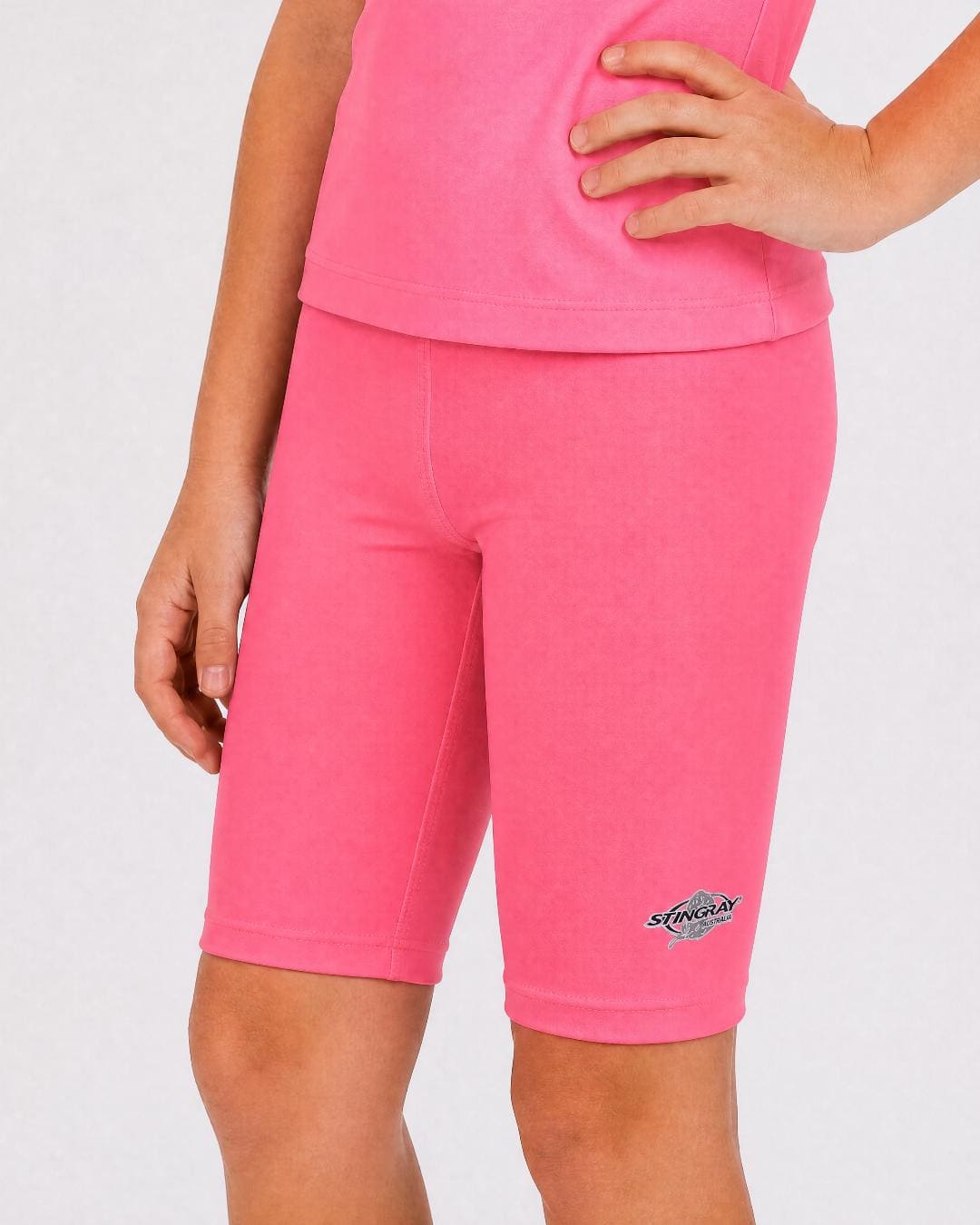 6 year old wearing pink UV swimming shorts/trunks UPF 50+ in a white studio