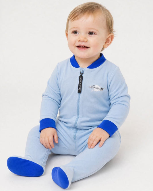 Baby wearing a light blue full-body UV swimsuit/onesie/romper UPF 50+ with dark blue accents on a white background