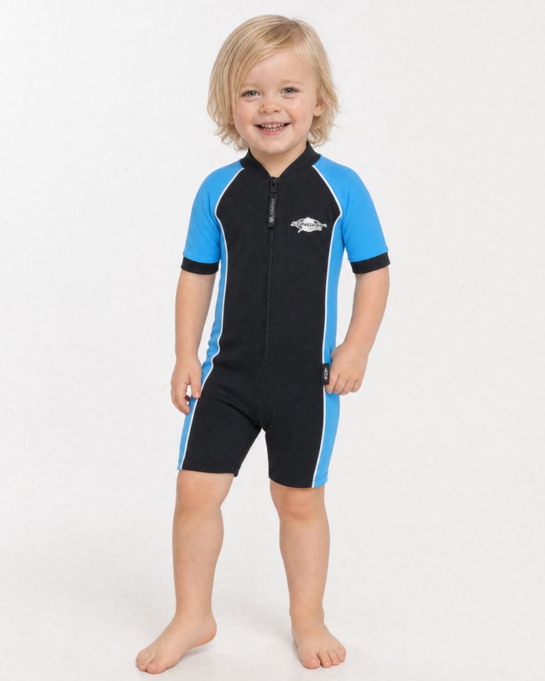 2 year old toddler wearing short sleeve UV sunsuit UPF 50+ in black and azure in a white studio 