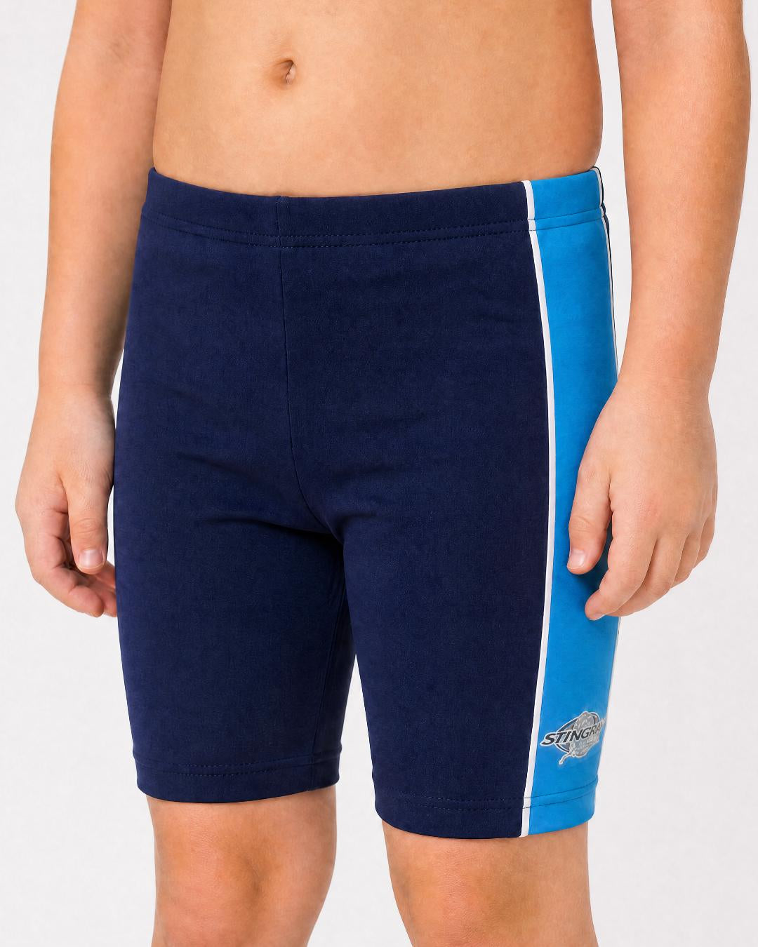 2 year old toddler/child wearing navy and azure UV swimming shorts/trunks UPF 50+ in a white studio