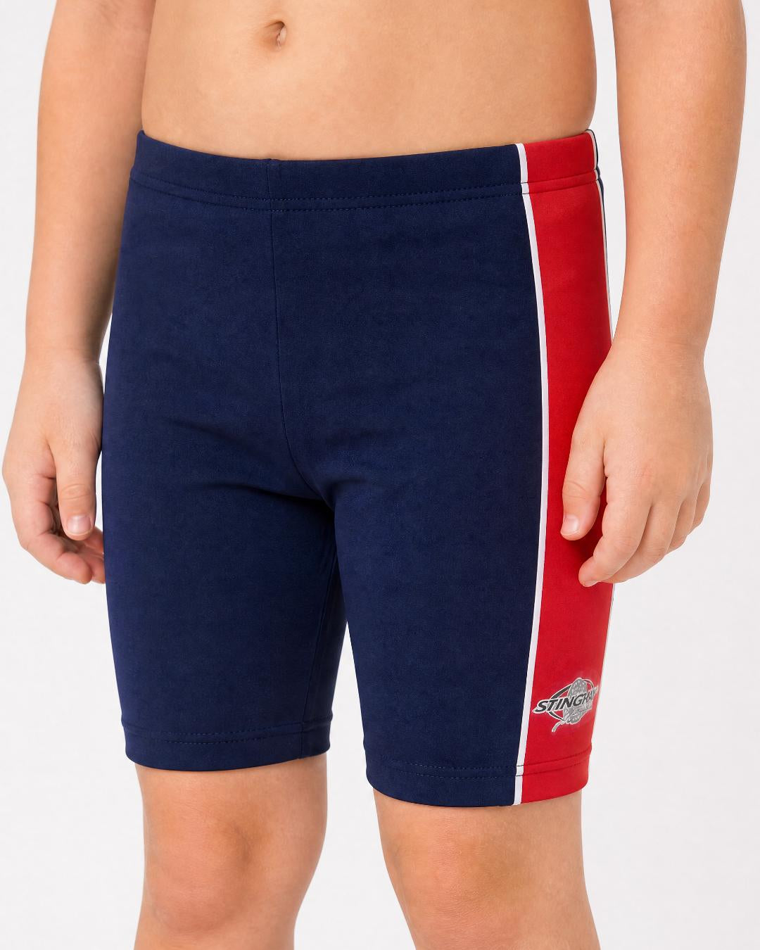 2 year old toddler/child wearing navy and red UV swimming shorts/trunks UPF 50+ in a white studio