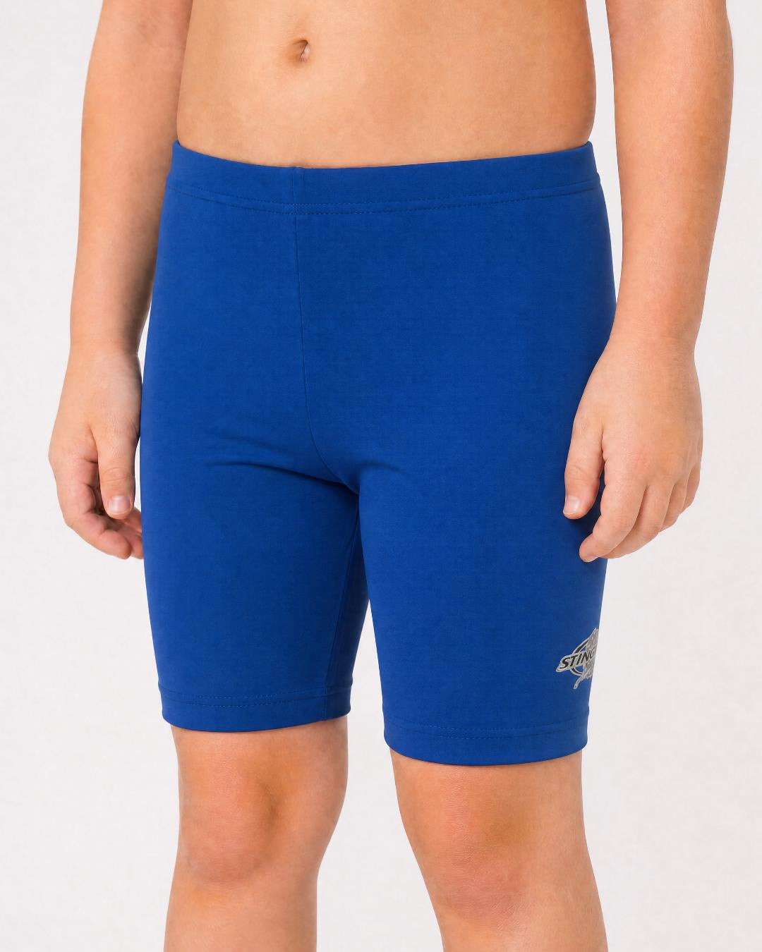 2 year old toddler/child wearing ocean blue UV swimming shorts/trunks UPF 50+ in a white studio