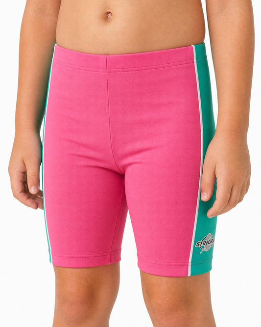 2 year old toddler/child wearing pink and teal UV swimming shorts/trunks UPF 50+ in a white studio