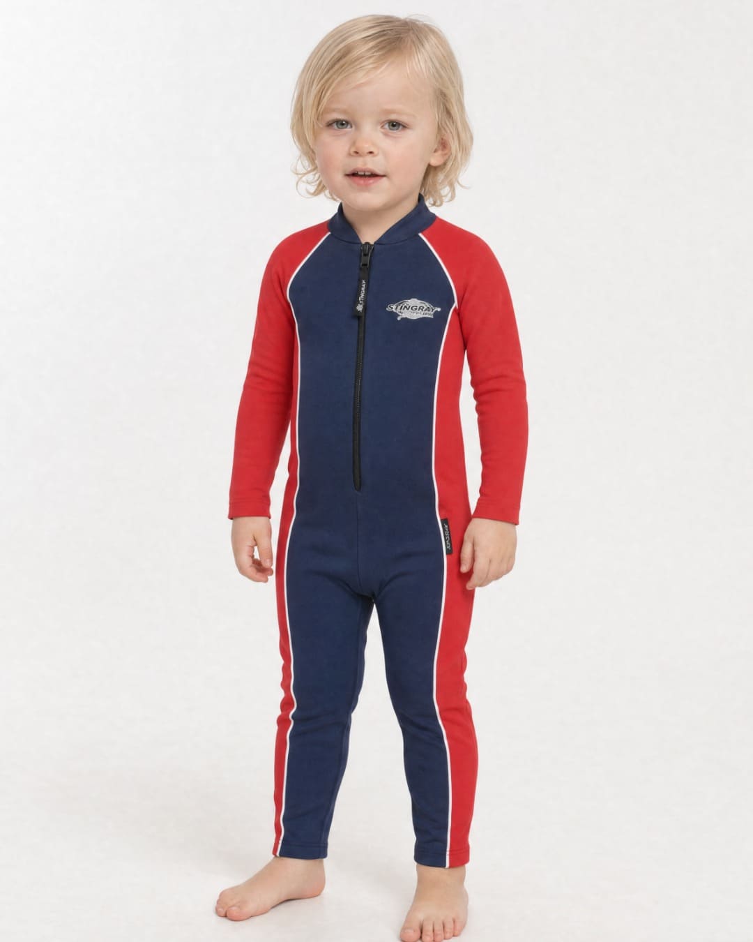 2 year old child/toddler wearing a full-body navy and red UV swimsuit UPF 50+ on a white background