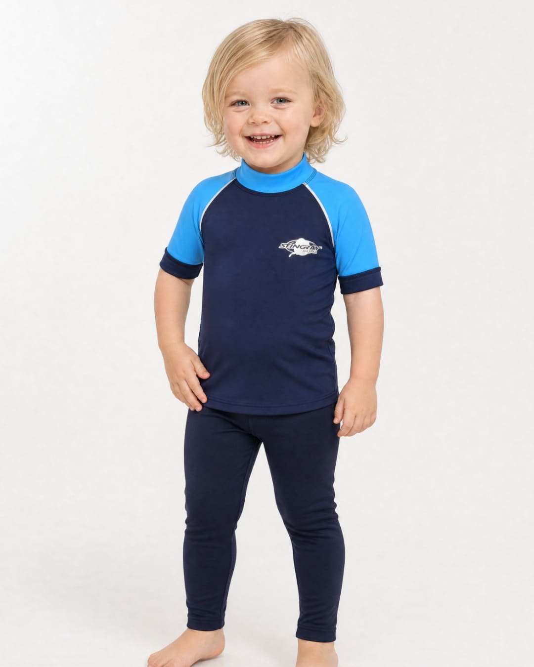 2 year old wearing a short sleeve UV swim shirt UPF 50+ in navy and azure in a white studio