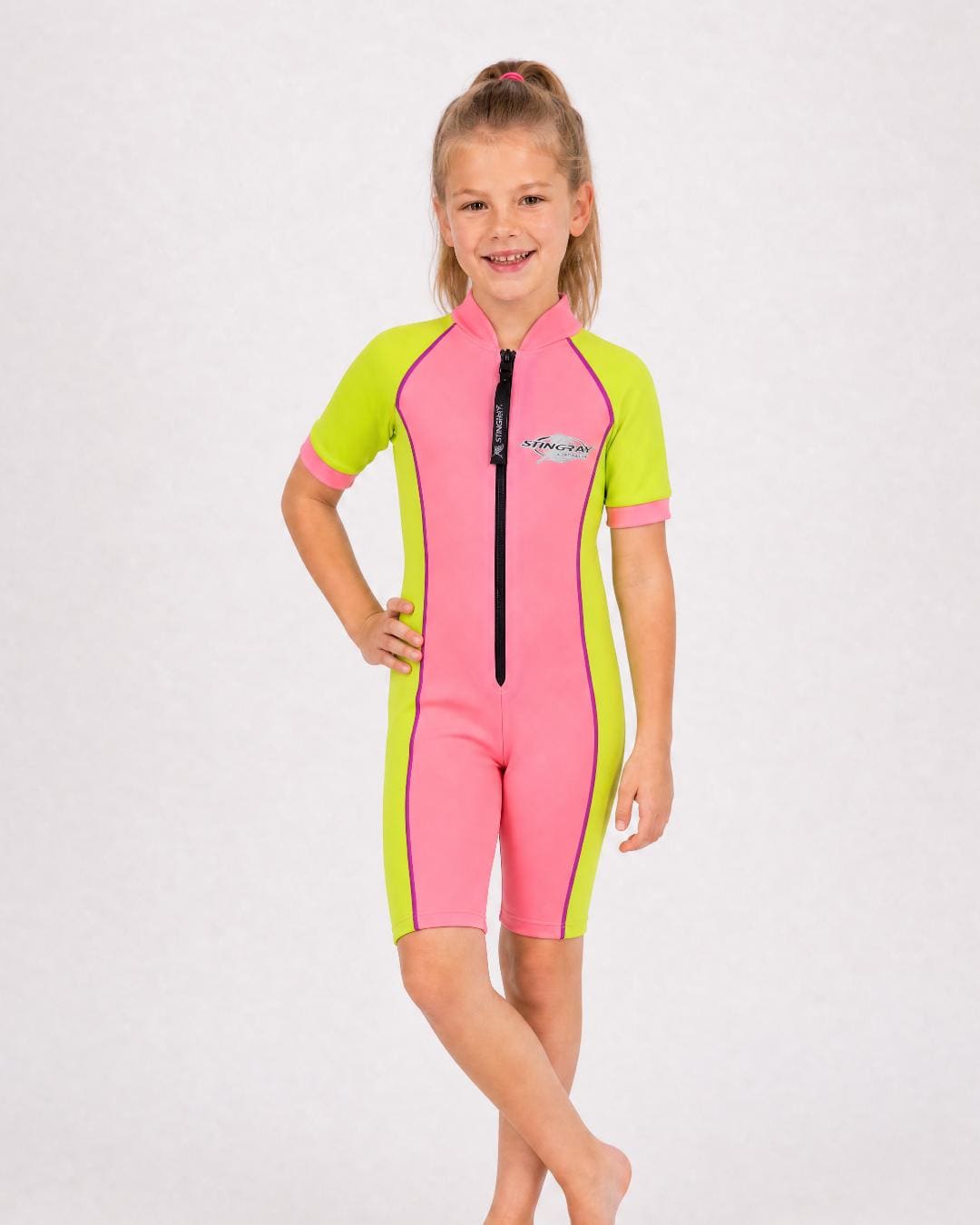 6 year old girl wearing a short sleeve uv swimsuit in pink and yellow