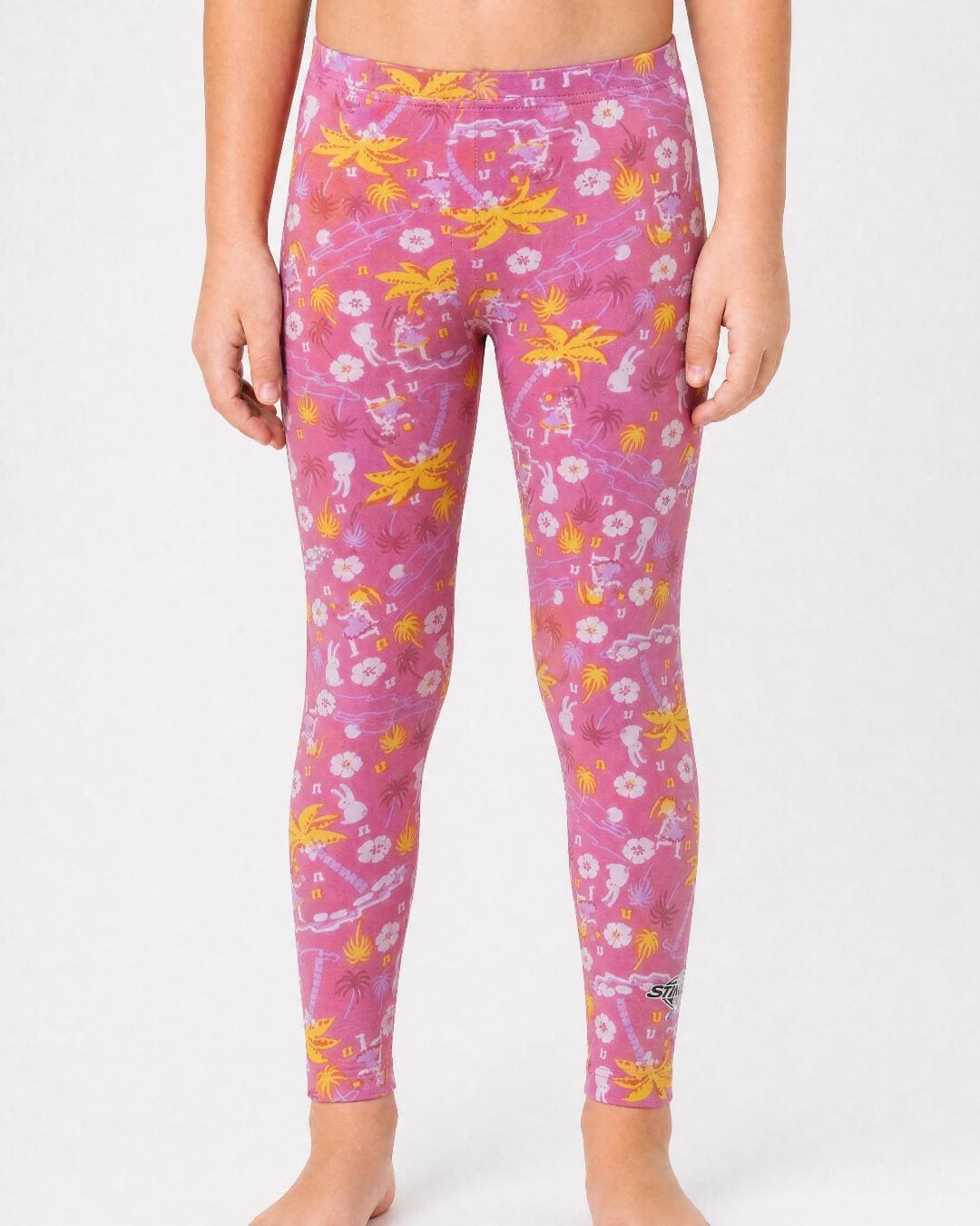 6 year old wearing floral pattern UV swim leggings UPF 50+ on a white background
