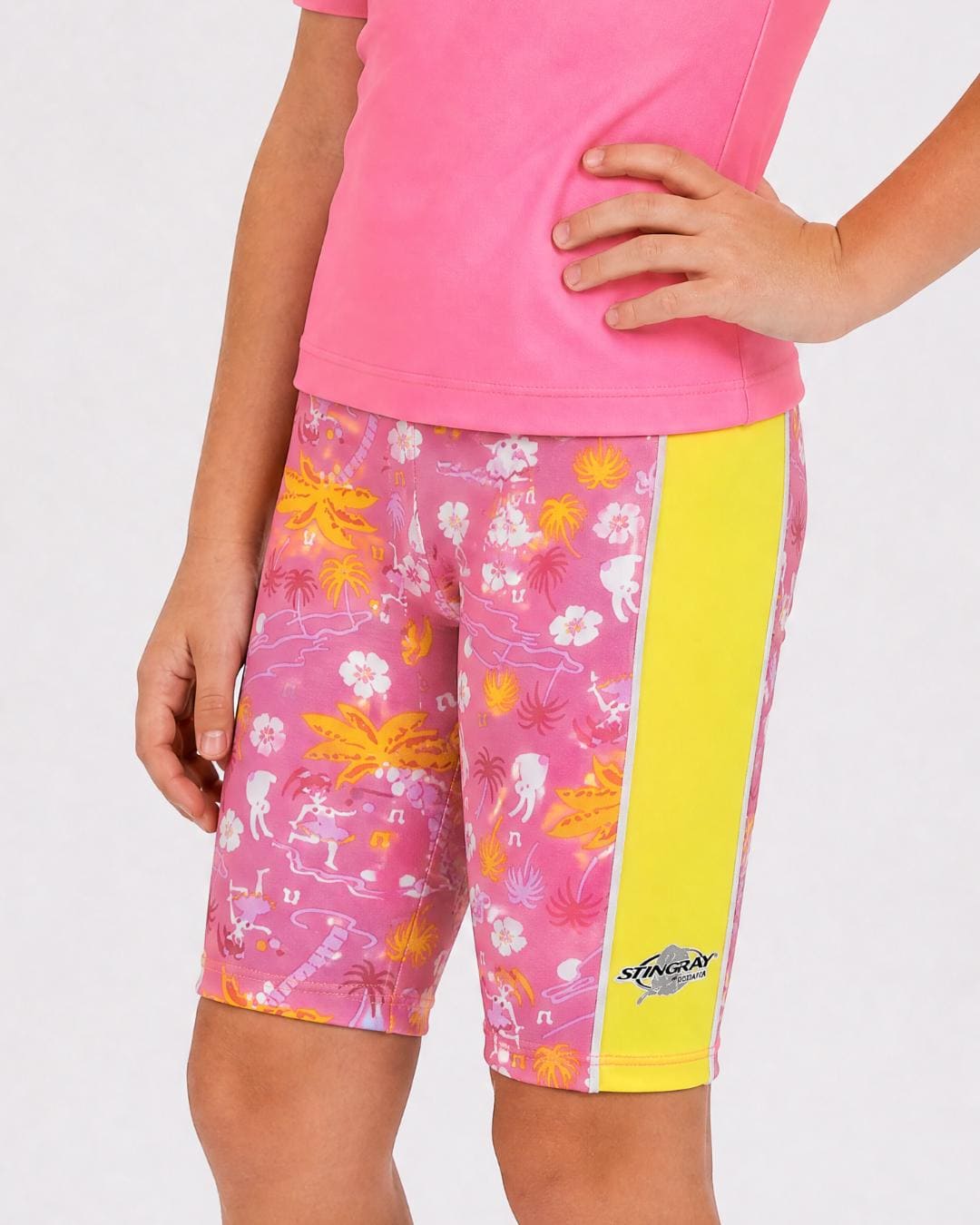 6 year old wearing floral and yellow UV swimming shorts/trunks UPF 50+ in a white studio