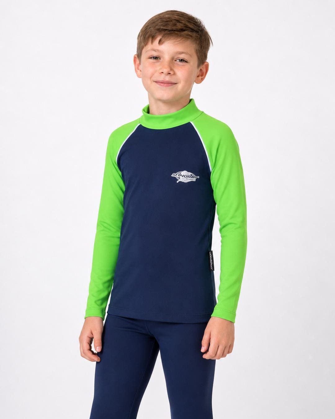 8 year old boy wearing a navy and lime long-sleeve UV rash vest on a white background