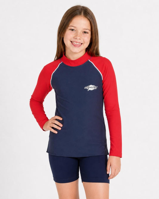 8 year old girl wearing a red and navy long-sleeve UV rash vest on a white background