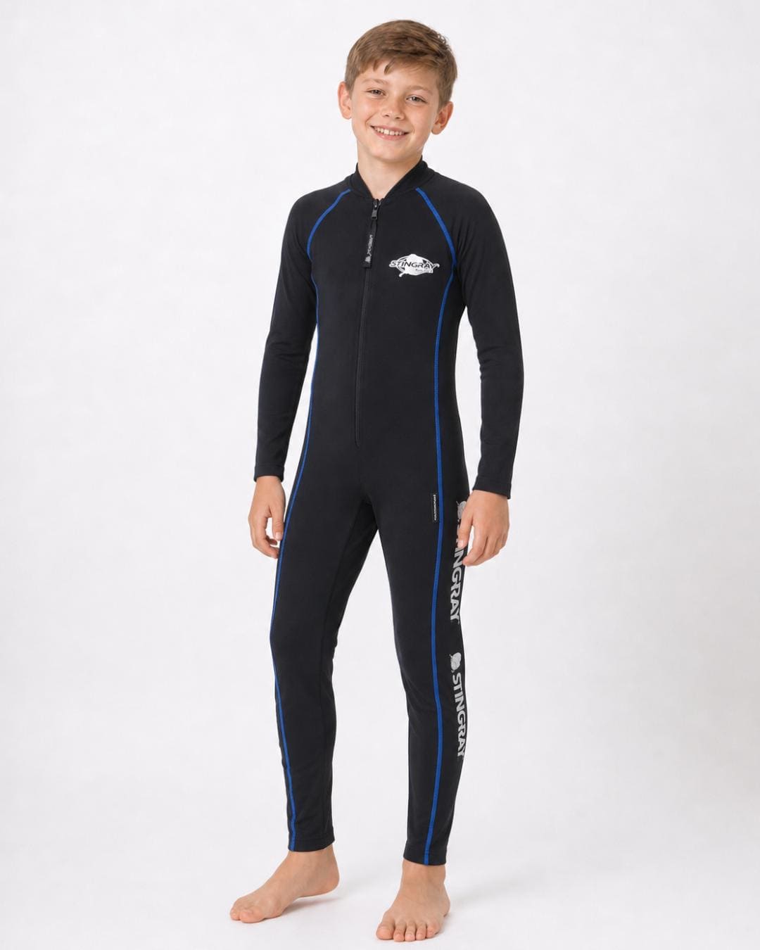 8 year old girl wearing a black, with blue stitching, full-body UV swimsuit on a white background