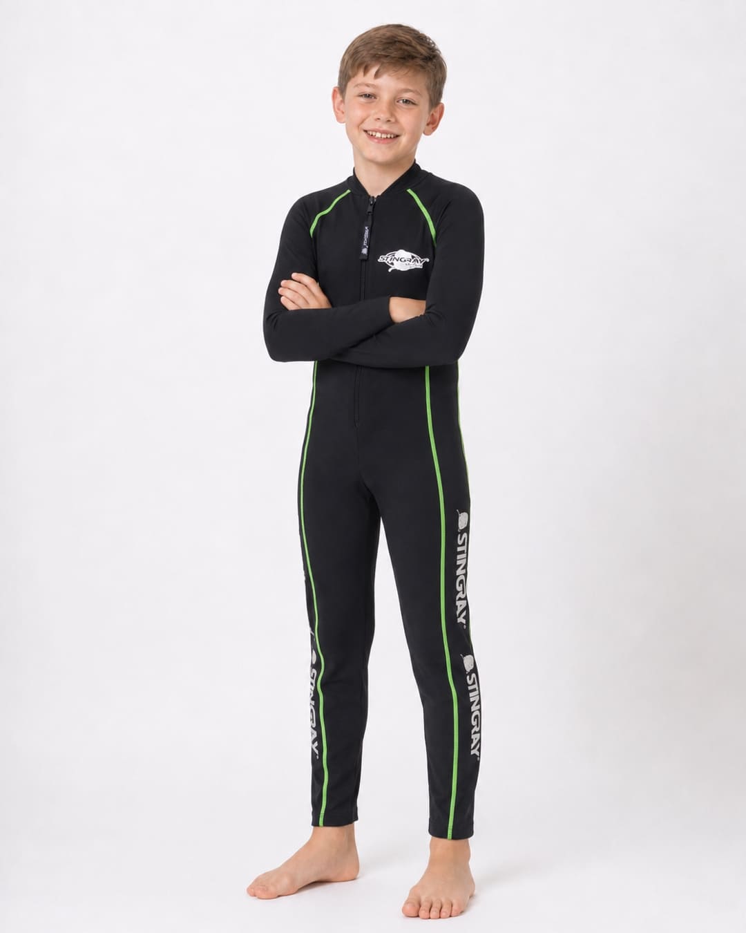 8 year old boy wearing a black, with green stitching, full-body UV swimsuit on a white background