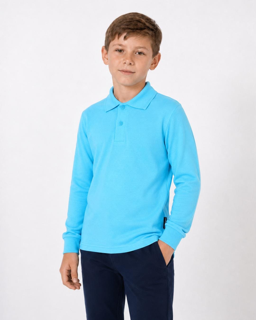 8 year old boy wearing a ice blue long-sleeve UV polo shirt and trousers on a white background