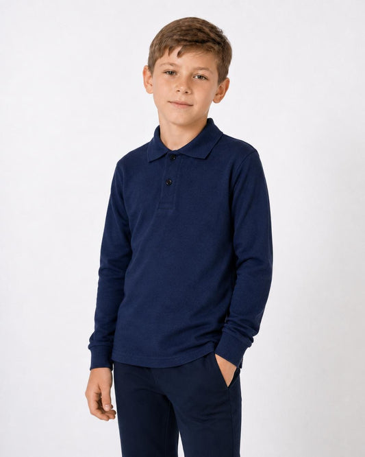8 year old boy wearing a navy long-sleeve UV polo shirt and trousers on a white background