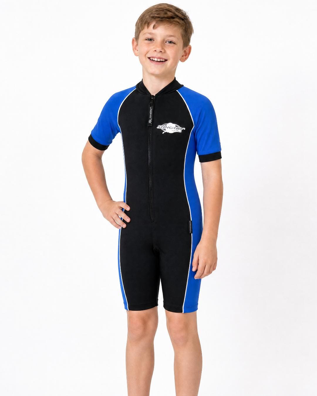 8 year old boy wearing a black and ocean blue short sleeve UV swimsuit on a white background