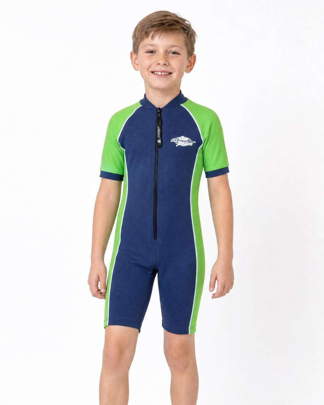8 year old boy wearing a navy and green short sleeve UV swimsuit on a white background