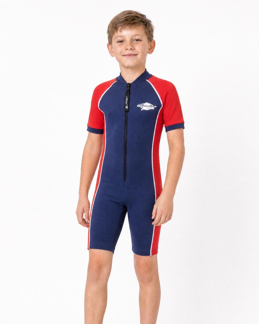 8 year old boy wearing a navy and red UPF 50+ short sleeve sunsuit on a white background