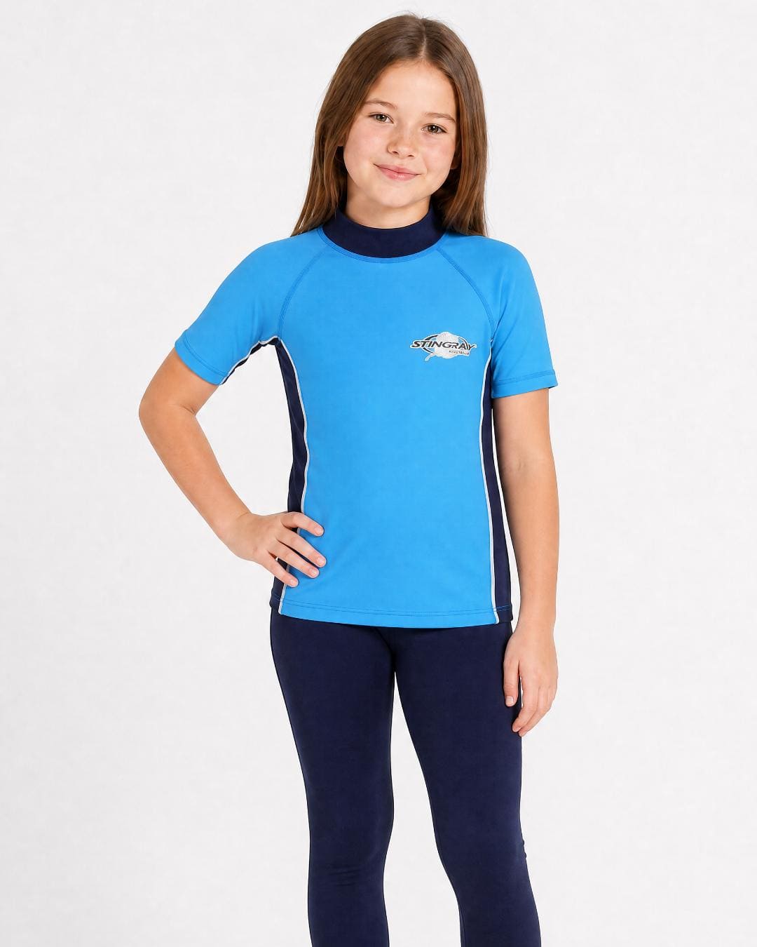 8 year old girl wearing UV rash vest UPF 50+ in navy and azure in a white studio