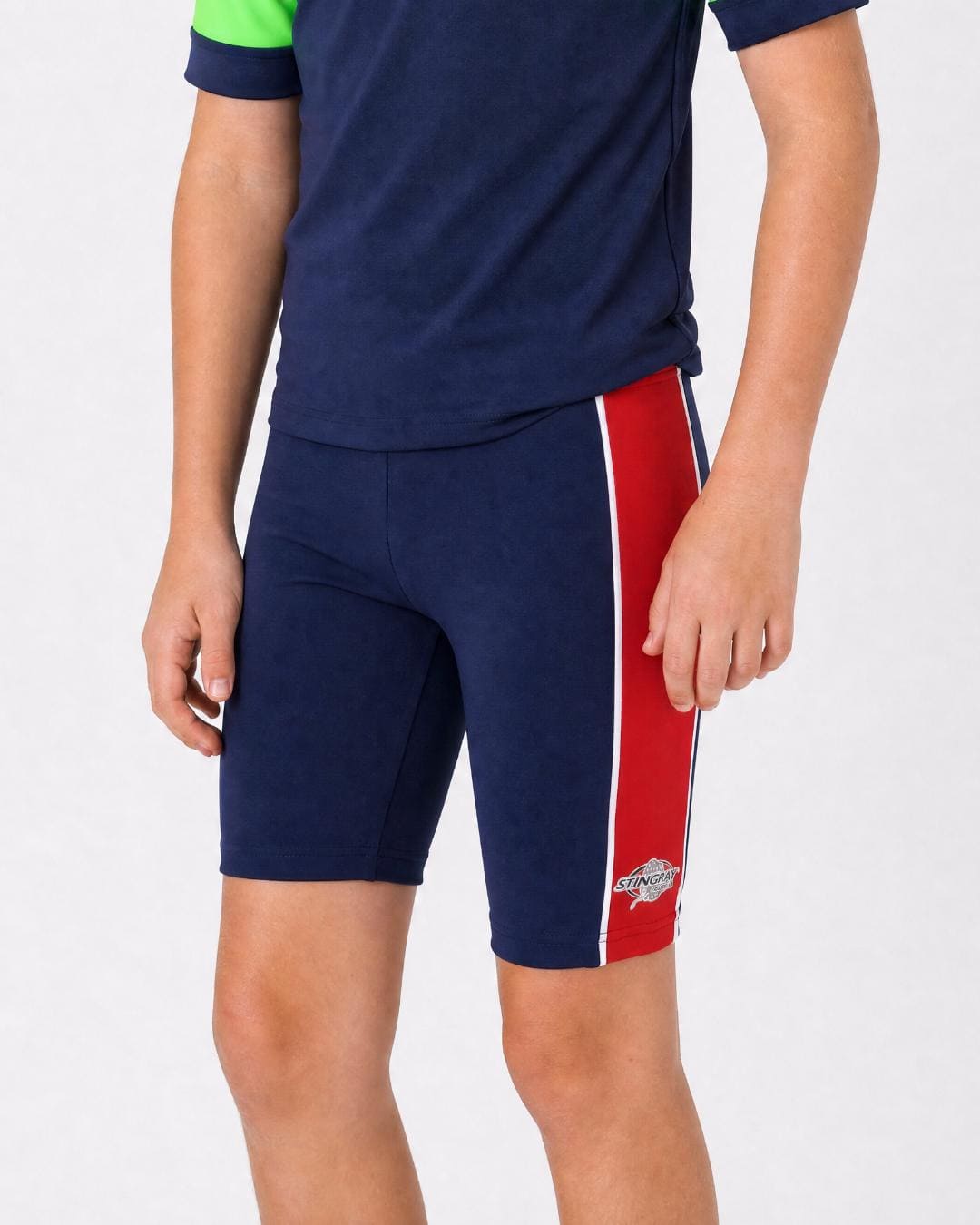14 year old wearing navy and red UV swimming shorts/trunks UPF 50+ in a white studio