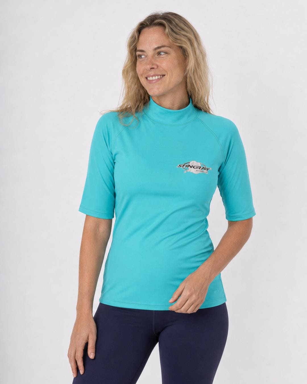 Woman wearing an aqua blue UV swim shirt UPF 50+ on a white background