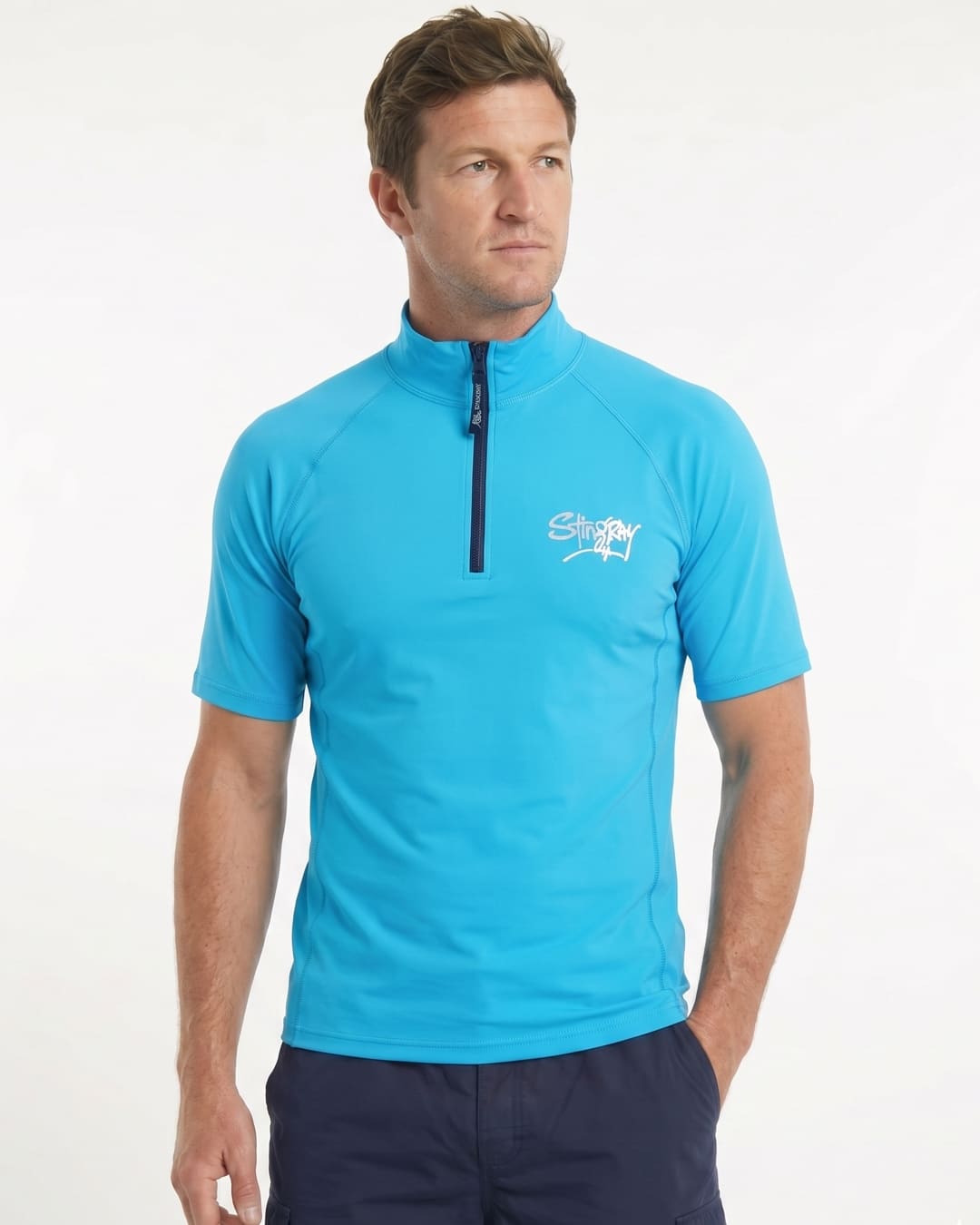 Man wearing a azure blue short-sleeve UV zipped rash shirt on a white background