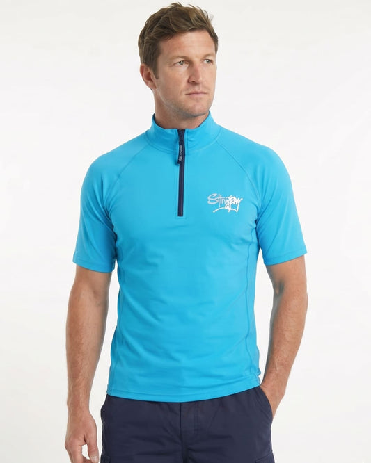 Man wearing a azure blue short-sleeve UV zipped rash shirt on a white background