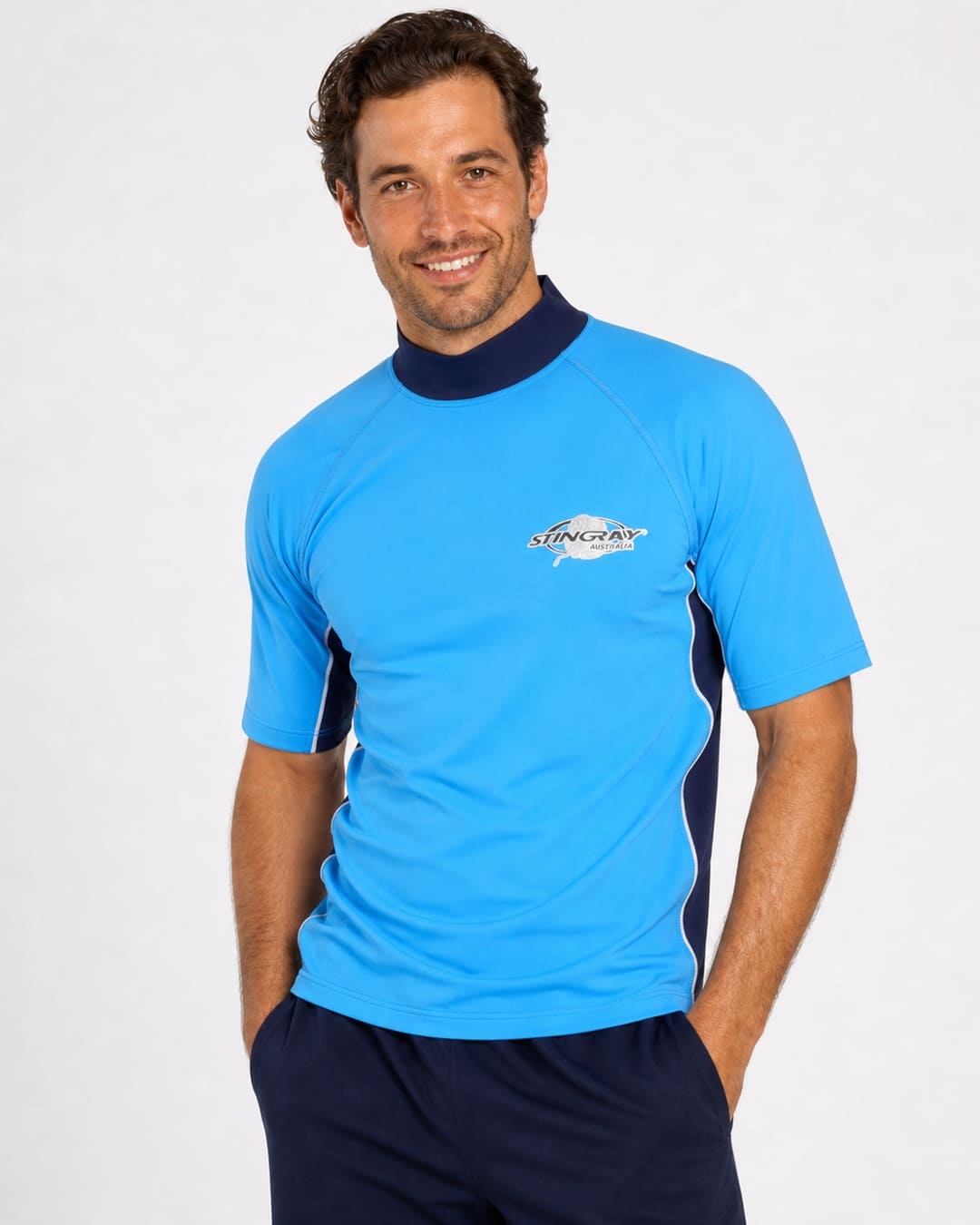 Man wearing azure and ocean blue UV swim shirt UPF 50+ in a white studio