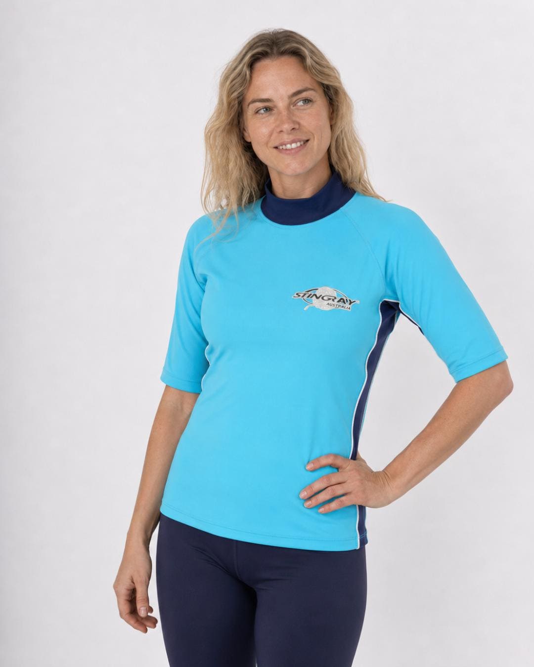 Woman wearing an azure and ocean blue UV swim shirt UPF 50+ on a white background