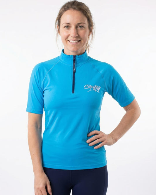 Woman wearing a blue zipped UV swim shirt UPF 50+ on a white background