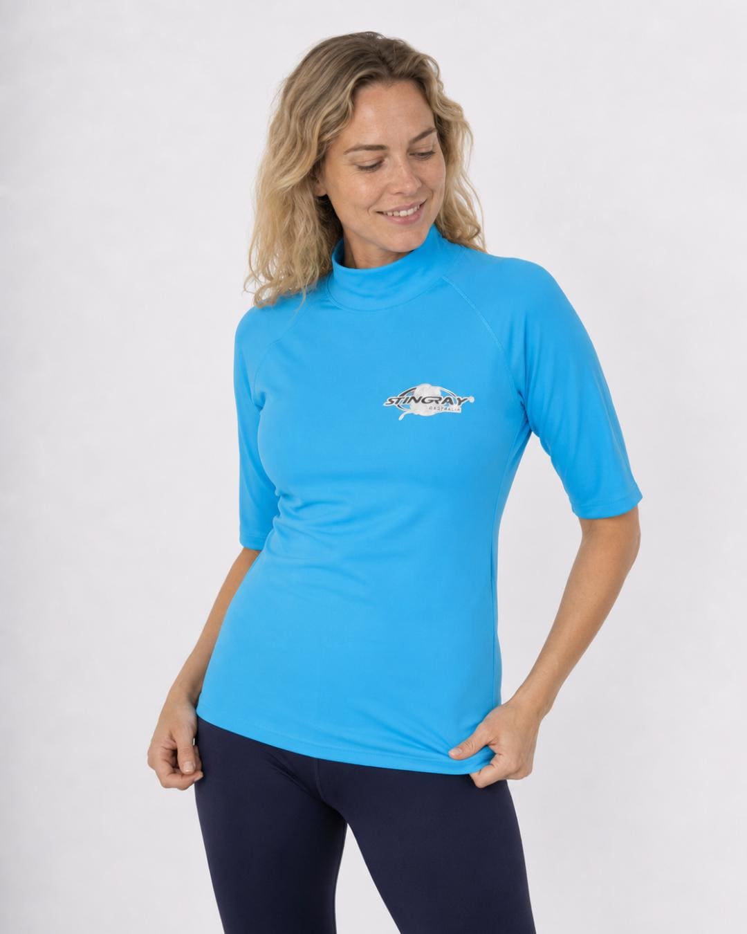 Woman wearing an azure blue UV swim shirt UPF 50+ on a white background