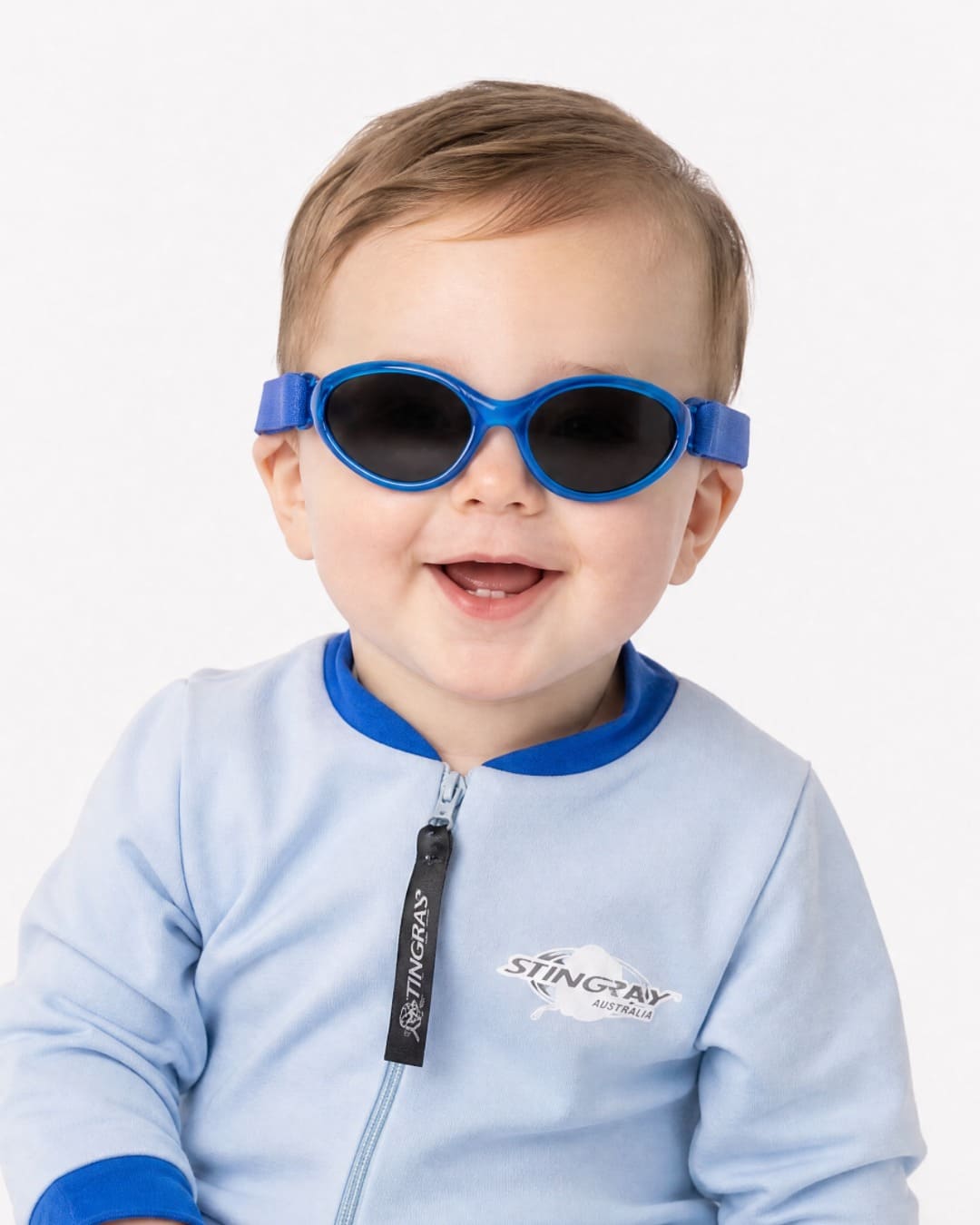 Baby wearing blue UV400 Baby Banz in studio