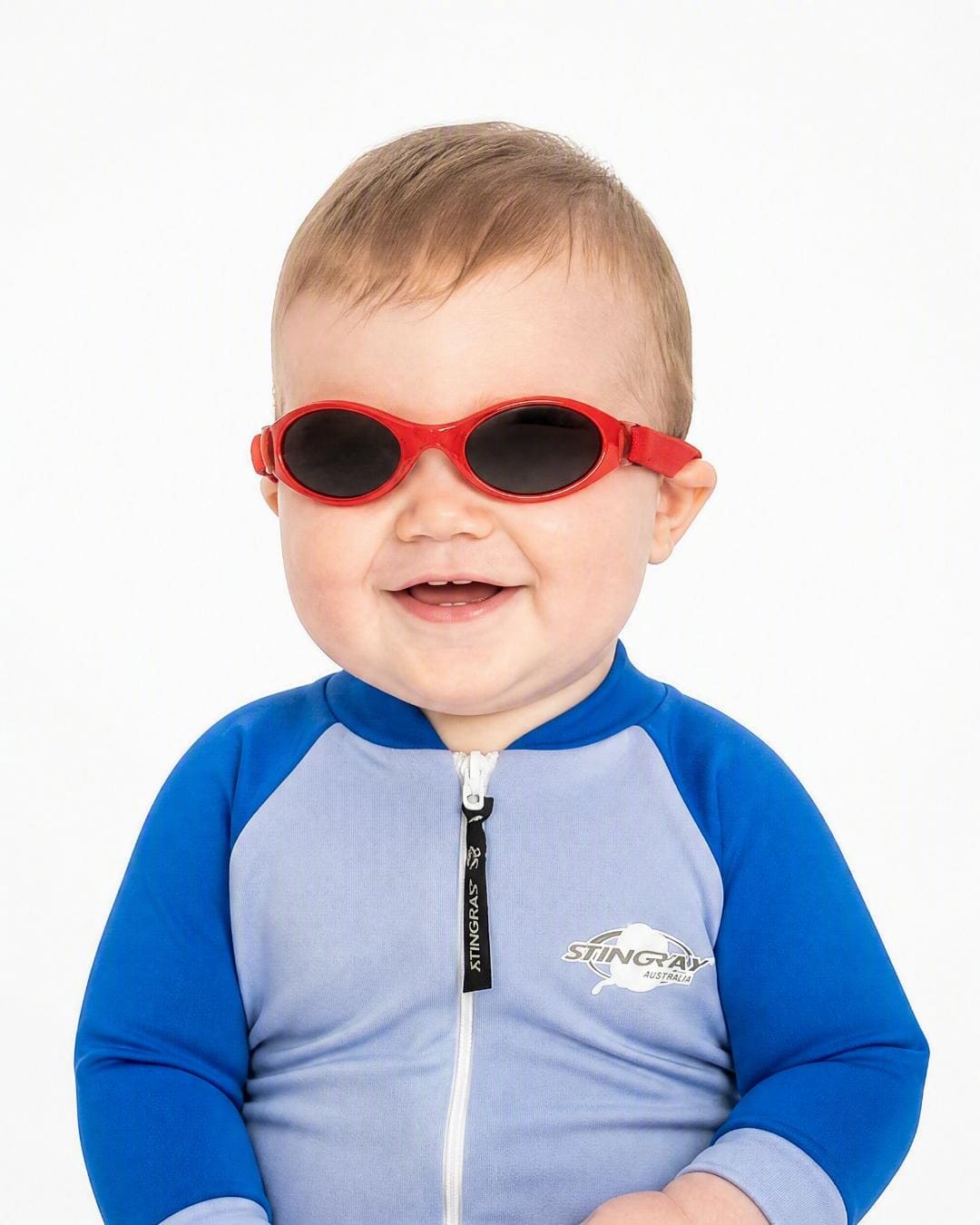 Baby wearing red UV400 Baby Banz in studio