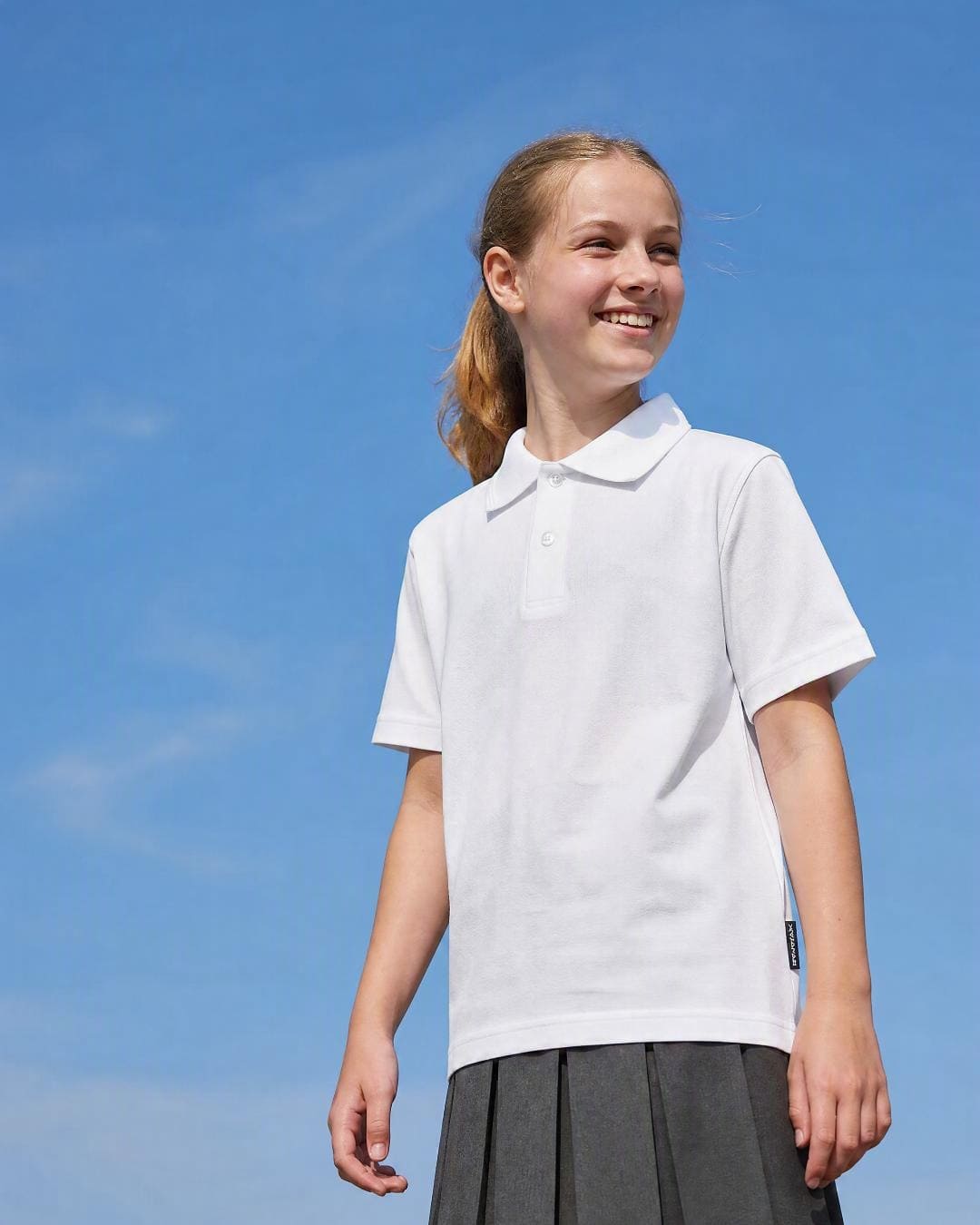 Back of 12 Year Old Girl Wearing Short Sleeve Polo Shirt - White