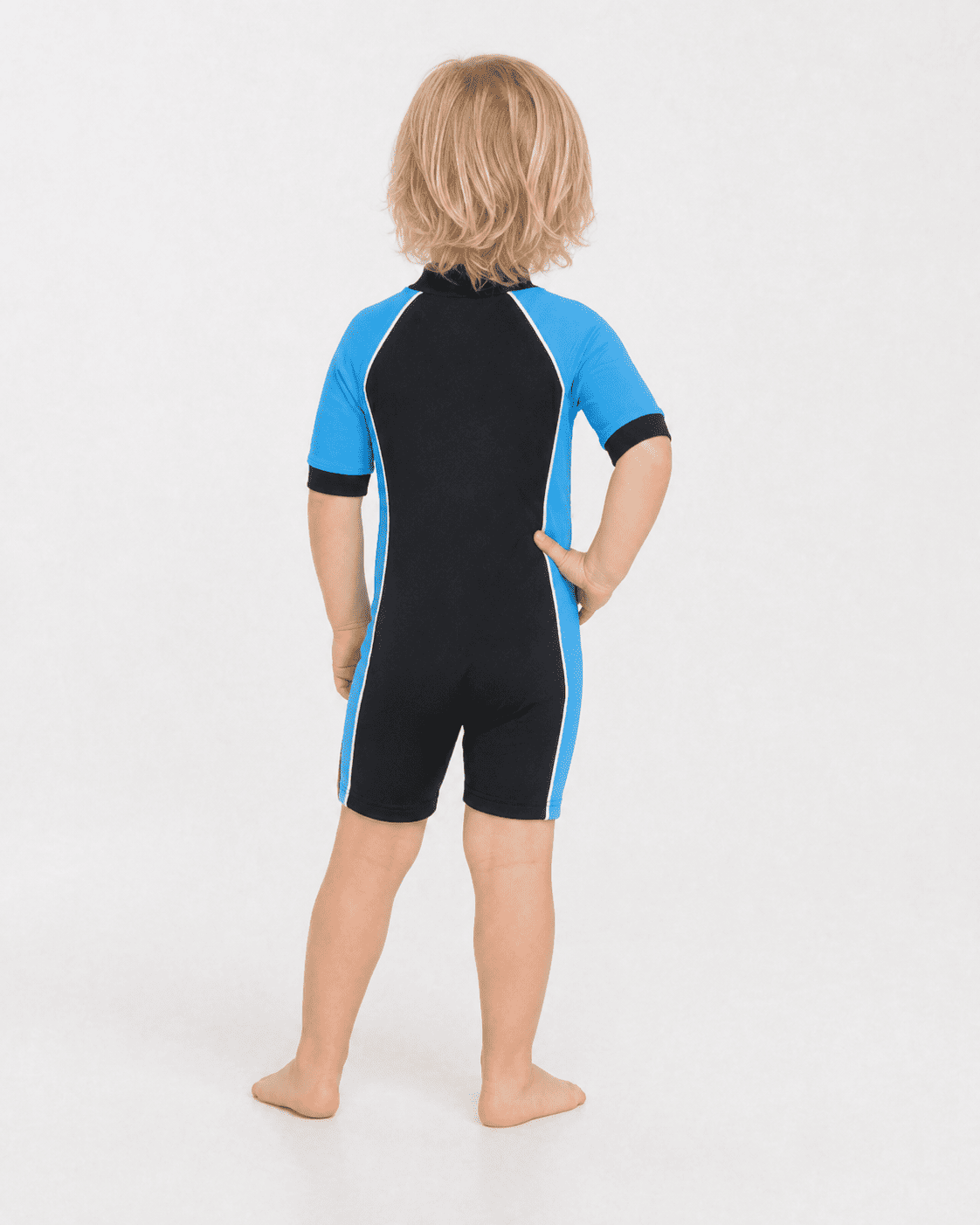 Back of 2 year old toddler wearing short sleeve UV sunsuit - black azure