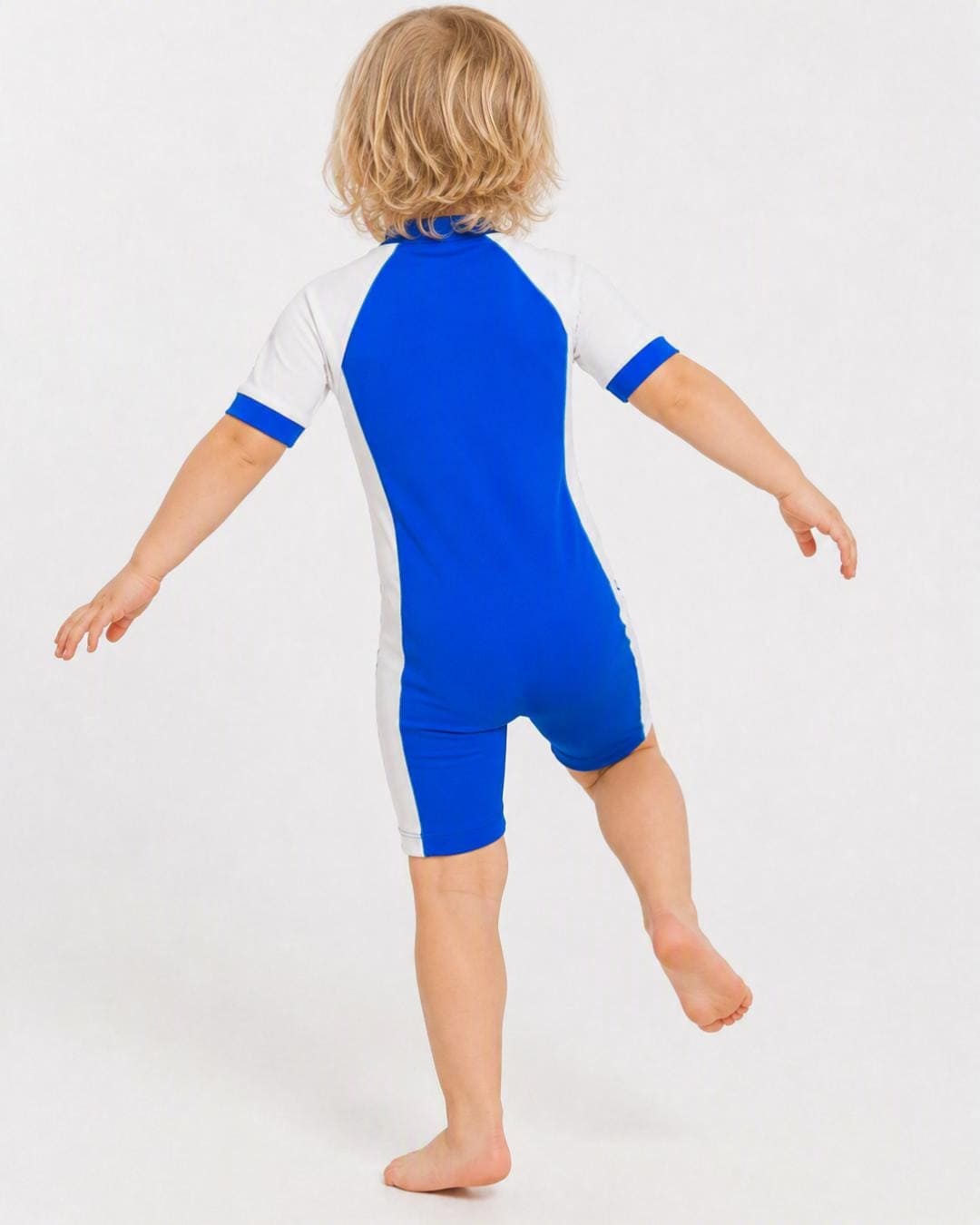 Back of 2 year old toddler wearing short sleeve UV sunsuit - blue white