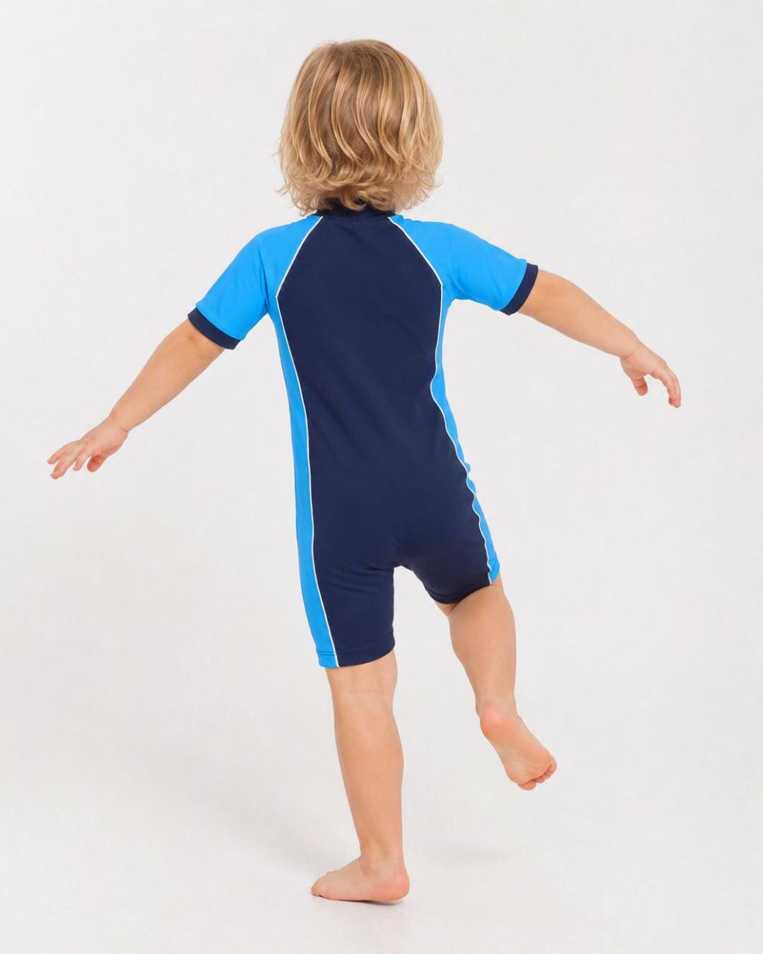Back of 2 year old toddler wearing short sleeve UV sunsuit - navy azure