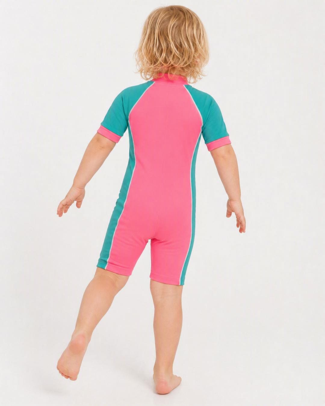 Back of 2 year old toddler wearing short sleeve UV sunsuit - pink teal