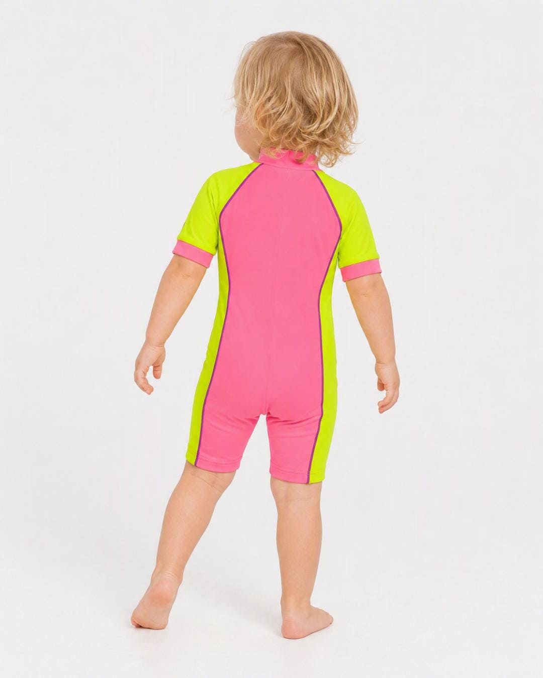 Back of 2 year old toddler wearing short sleeve UV sunsuit - pink yellow